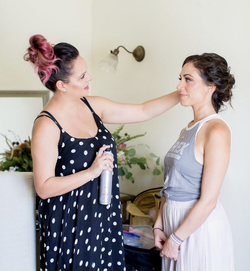 Hairstylist doing bridal hair in polkadot dress