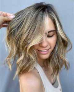 Golden blonde highlights with a side part