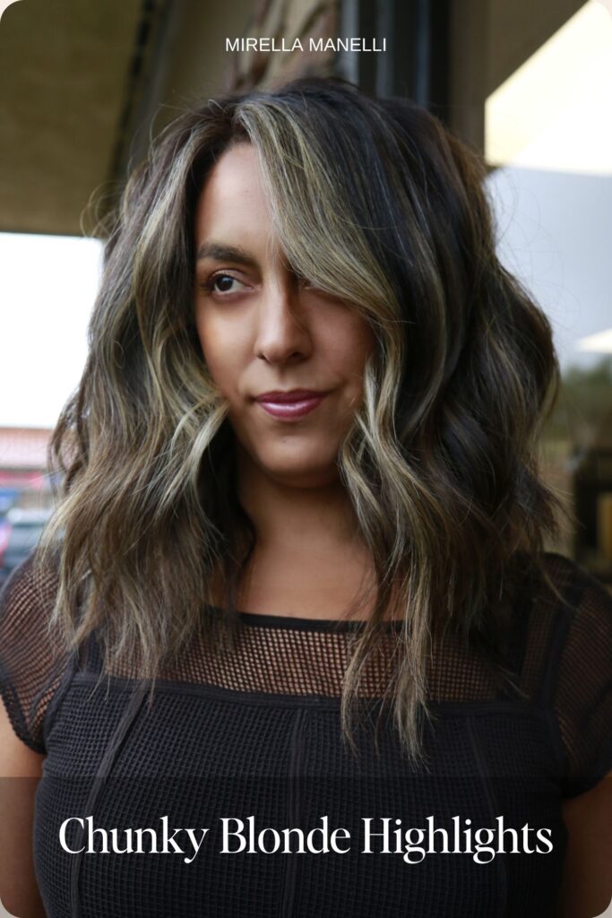 Chunky blonde highlights on dark brown wavy hair