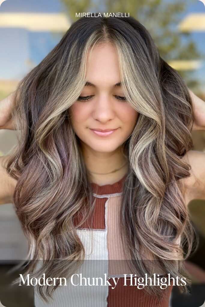 Modern chunky blonde highlights on brown wavy hair